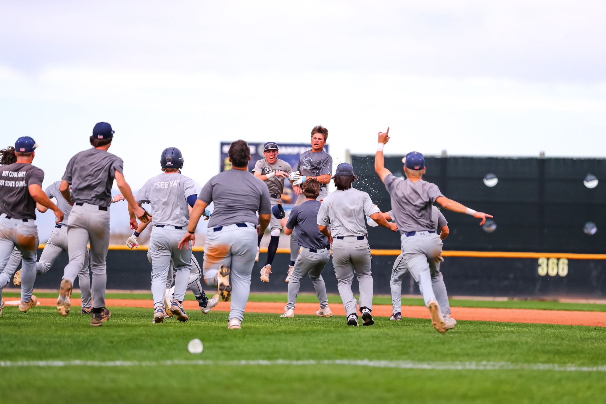 Casteel players running together to celebrate on the field