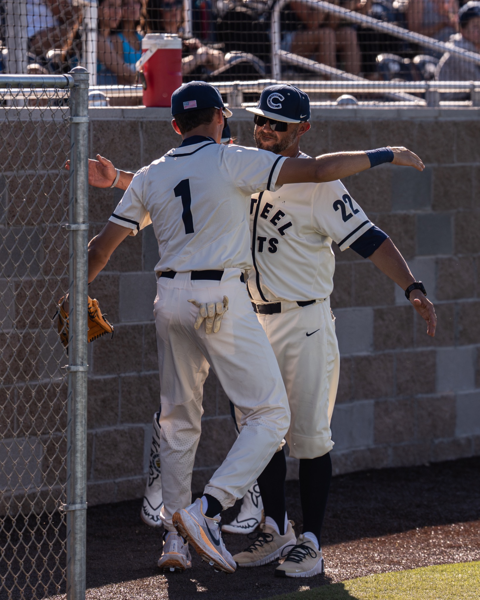 Casteel player and coach celebrating near the dugout