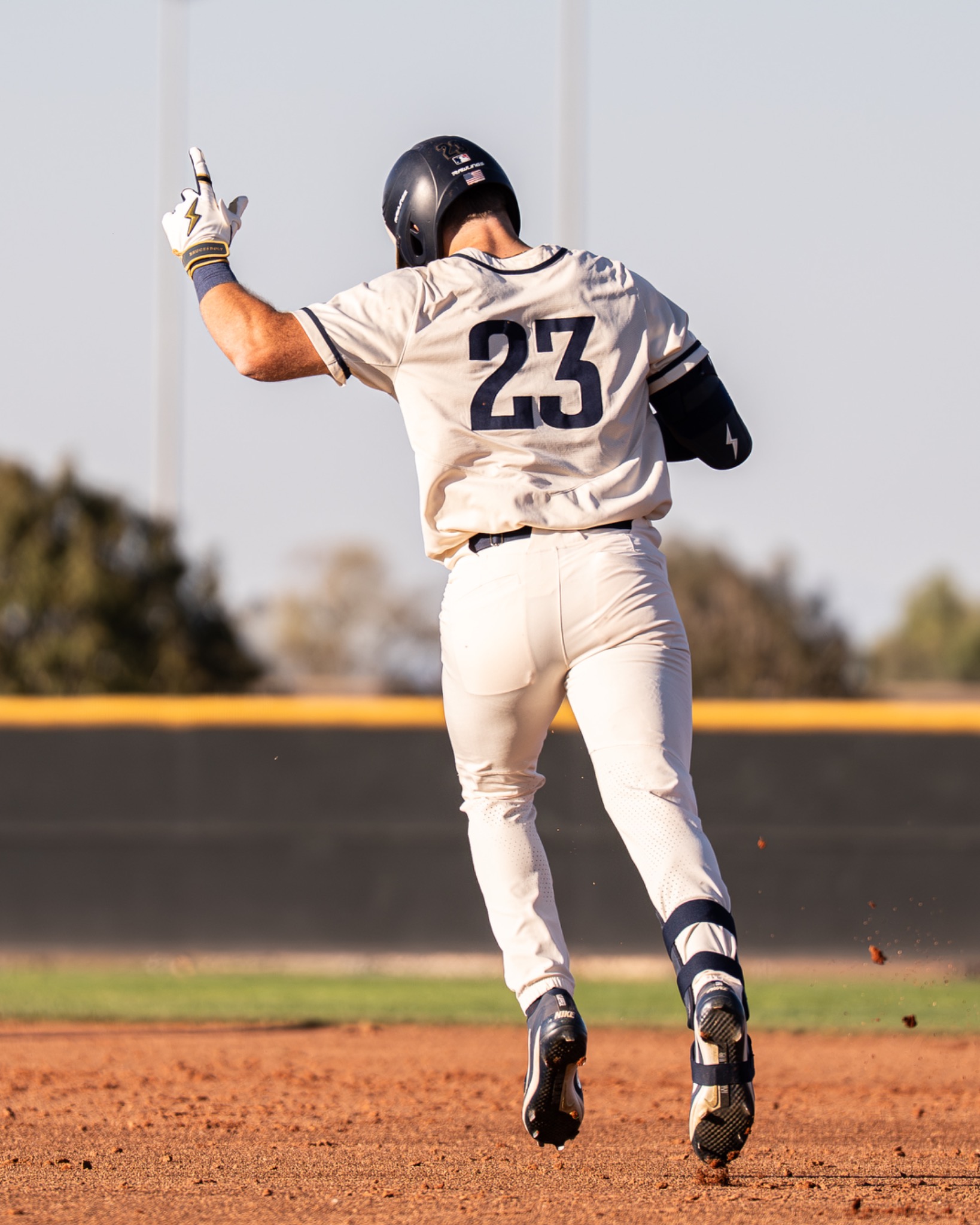 Casteel Baseball player wearing number 23 rounding the bases