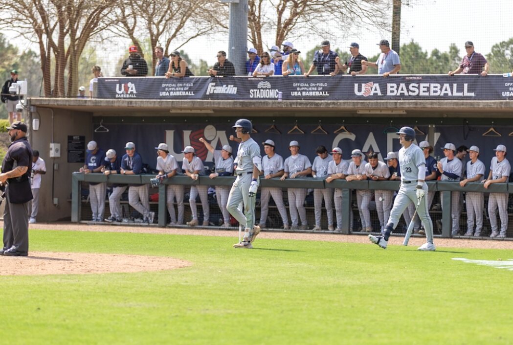 Casteel hitters and teammates in front of the dugout