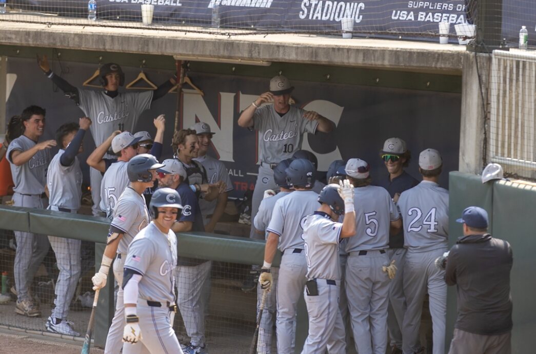 Casteel players celebrate in the dugout