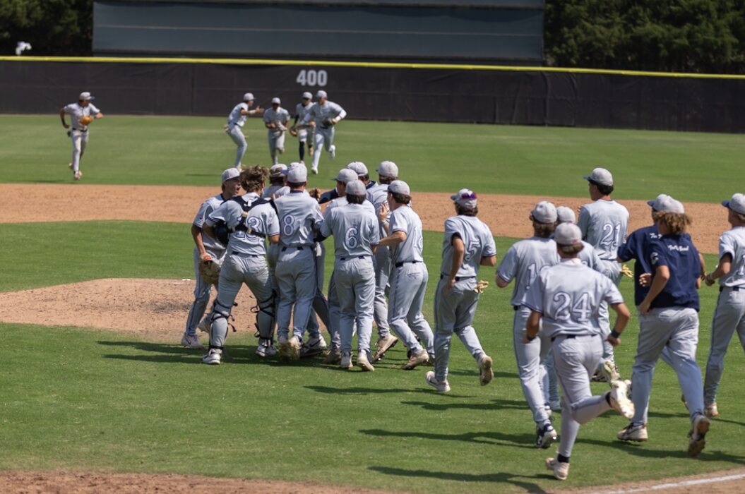 Casteel Baseball players rush the field after defeating St. John Bosco